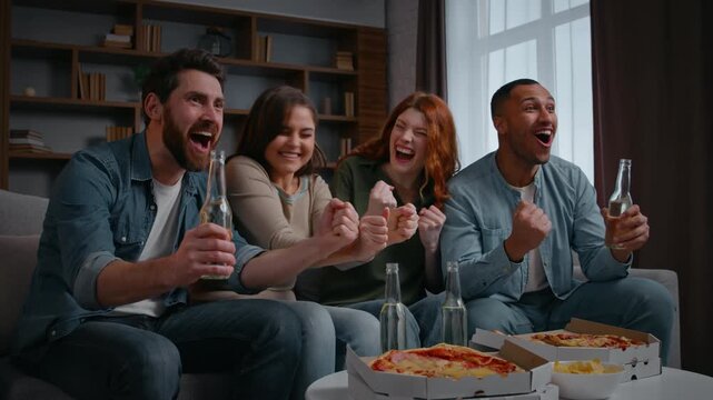 Excited four multiracial friends rejoice watching tv yelling happy at home party with pizza beer supporting sport team football match diversity people sport fans watch television celebrating winning