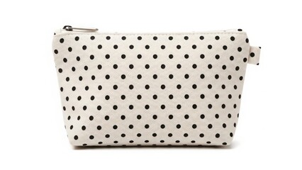 Minimal polka dot cosmetic bag with neutral fabric and zipper isolated