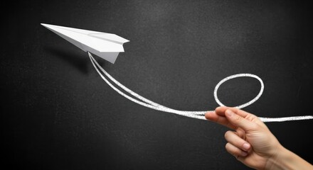 Idea innovation success launch flight A creative concept showing a hand sending a paper airplane along a chalk trajectory loop evoking playful optimism and ambition