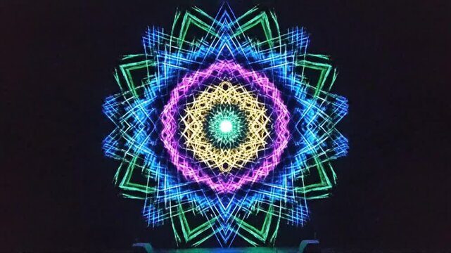 Vibrant neon mandala with colorful geometric patterns on black background