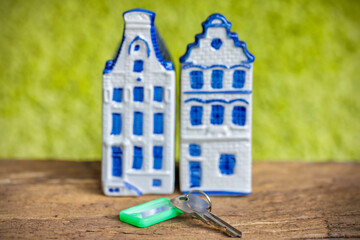 Concept of buying or renting a Dutch house with small canal houses and home key