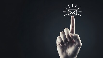 Finger pointing at a glowing envelope on a dark background