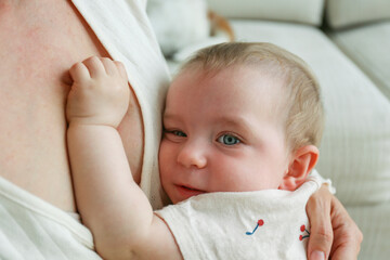 Baby girl hugging her mother. Copy space, background.