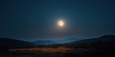A full moon illuminates a serene night landscape with rolling hills and a dark sky