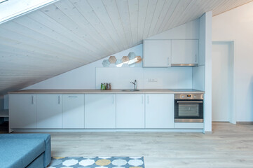 Modern Loft Kitchen with Sleek Cabinets and Stylish Wooden Ceiling