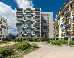 Modern Apartment Complex Featuring Outdoor Fitness Area and Landscaping Under Clear Skies