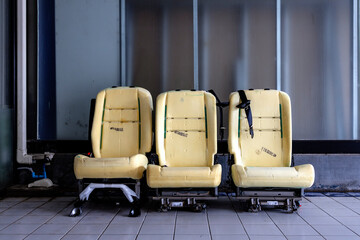 Removed Car Seats With Exposed Foam Lining in Vehicle Repair Workshop