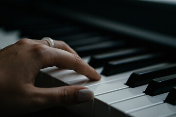 Fototapeta premium Piano keys person plays classical music black and white