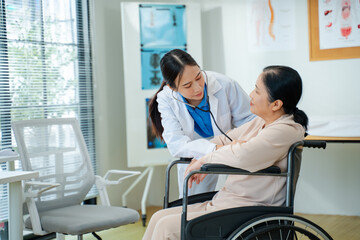 Female doctor using digital tablet explaining diagnosis to female elderly patient on wheelchair.medical service and help in hospital.telehealth and people on digital tech for diagnosis concept.