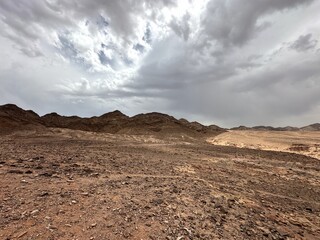 Barren arid desert with stormy weather and rugged natural