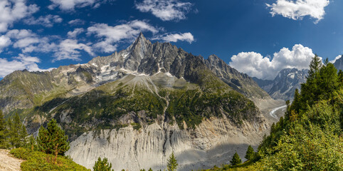 Fototapeta premium Panorama of the Alps in Chamonix, France, with snow covered peaks, alpine valleys, and rugged mountain terrain. High altitude landscape showing European mountain environment, outdoor adventure, skiing