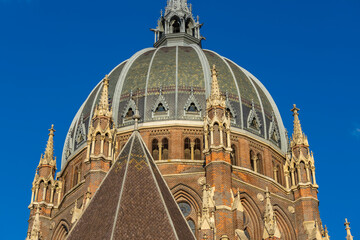 Naklejka premium Panorama of Maria vom Siege Kirche church in Vienna, Austria, with baroque architecture, domes, and surrounding urban landscape. Historic religious landmark showing European cultural heritage, citysca
