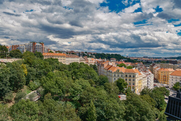 Breathtaking panoramic view of Prague, showcasing its historic city center with iconic buildings, charming red-roofed houses.