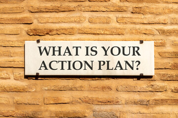 What is your action plan symbol. Concept words What is your action plan on beautiful white marble sign plate. Beautiful brick wall background. Business what is your action plan concept. Copy space.