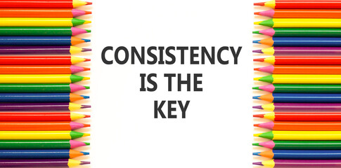 Consistency is the key symbol. Concept words Consistency is the key on beautiful white paper. Beautiful white background. Colored pencils. Business consistency is the key concept. Copy space.