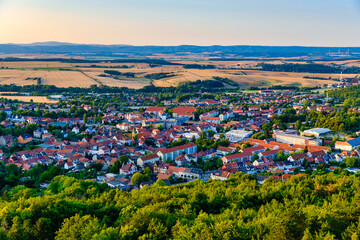 Captivating drone shot revealing picturesque cityscape with bustling outdoor cafes and lush surroundings