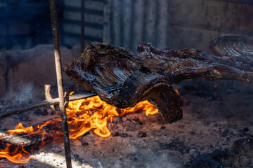 Traditional Patagonian style barbecue slow roasting over a campfire