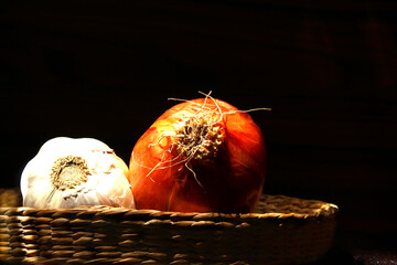 Onion and garlic in wicker basket. Brazilian spices. 
