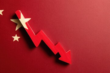 Wooden red arrow points down on a red surface with yellow stars, mimicking a flag