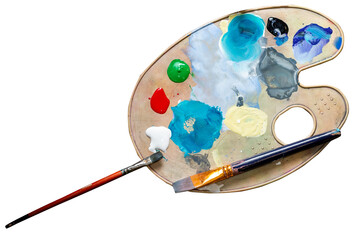Palette with multi-colored paints and brushes top view