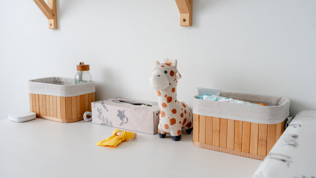Cozy nursery setup with toy giraffe and storage baskets