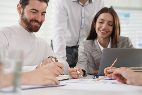 Businesspeople working together at table in office - Powered by Adobe