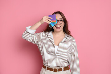 Designer with color palette samples on pink background