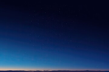 Dark blue sky filled with stars, transitioning to lighter blue near horizon