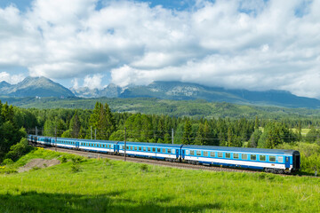 Fototapeta premium Passenger train winding through High Tatras mountains
