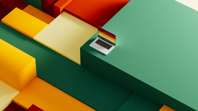 Laptop sits on geometric background with colorful cube shapes