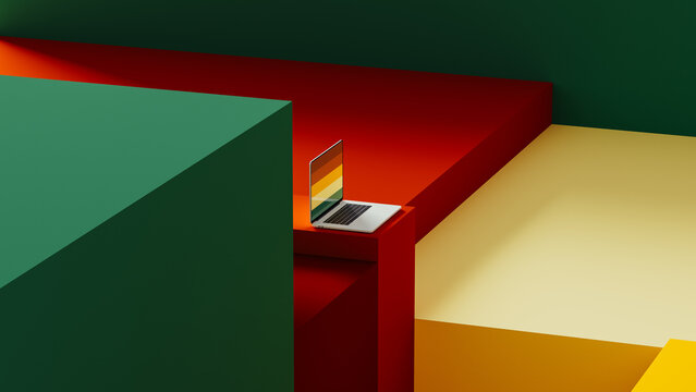 Laptop sits on geometric background with colorful cube shapes