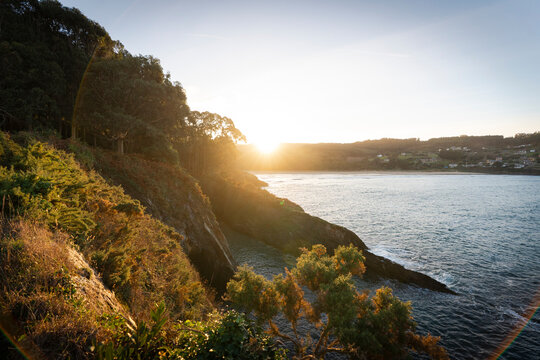 Sunset over Cova da Doncela's coastal landscape