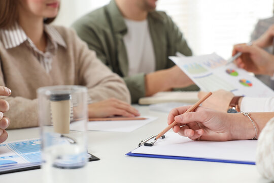 Businesspeople working together at table in office, closeup - Powered by Adobe