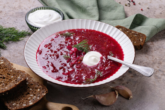 Cozy homemade beetroot soup with creamy garnish