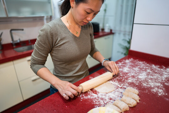 Woman rolling dough for homemade pita bread