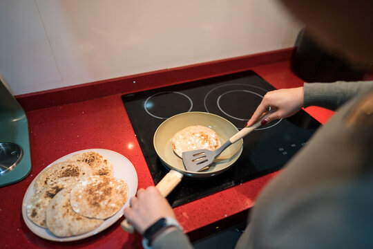 Cooking homemade pita bread on a stovetop