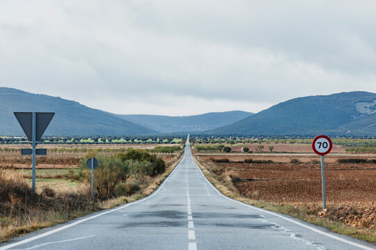 Endless road through open landscape with infinite horizon