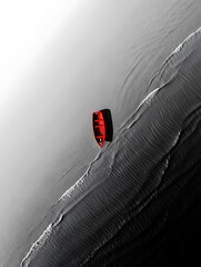 Aerial view of a red surfboard on a wave in the ocean water sports