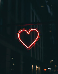 Vibrant Neon Heart Displayed in Urban Setting at Night Illuminating Darkness Elegantly