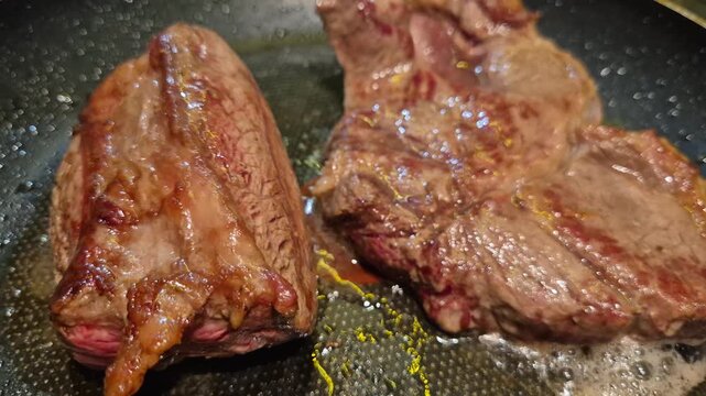 Close-up of pieces of beef being fried in a frying pan