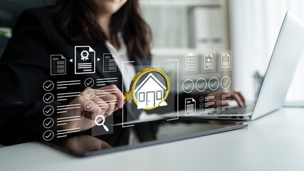 A business professional uses a laptop to analyze real estate data, supported by digital graphics...