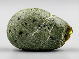 Tangled fibrous green actinolite aggregate representing the nephrite jade variety with a dense felted mineral texture.