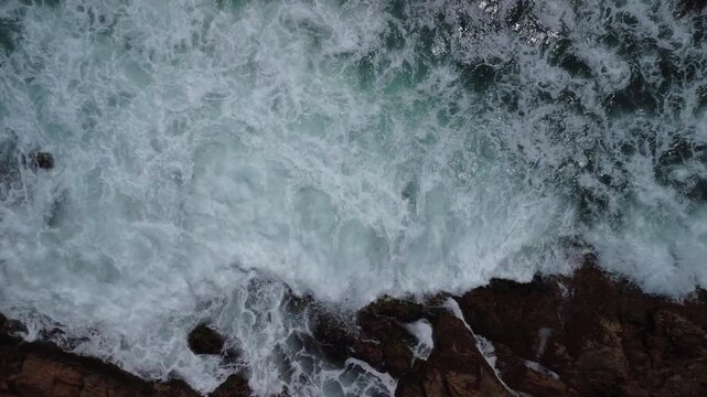 Turquoise Waves Crashing on Rocky Coastline &ndash; Garopaba, Brazil aerial drone shot
