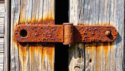 Rusty Metal Hasp on Weathered Wooden Door