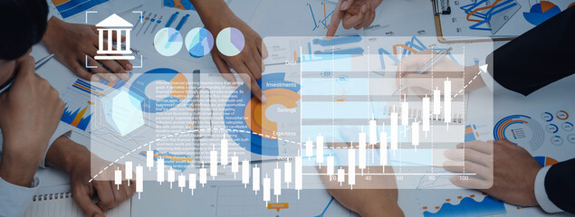 Professionals engage in a strategic meeting analyzing financial growth with charts and graphs, highlighting teamwork and collaborative efforts in a modern workspace. Gantry