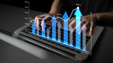 A person typing on a laptop with a digital overlay of upward graphs, symbolizing business growth, performance metrics, and strategic success in a modern office environment. Scalp