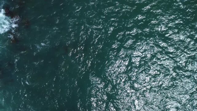 Turquoise Waves Crashing on Rocky Coastline &ndash; Garopaba, Brazil aerial drone shot