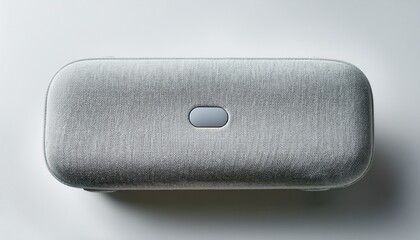 a light grey fabric covered portable speaker with a rounded oblong shape and subtle top controls