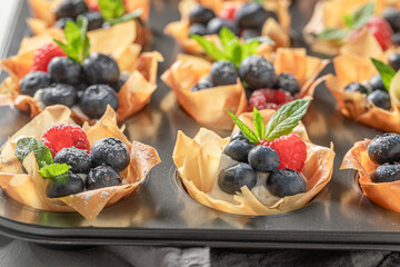 Tasty and hot phyllo cups made of beries and cream.