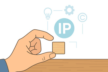 A hand holds a wooden block on a desk while an intellectual property icon appears on a virtual screen